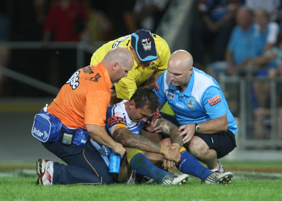 Mat Rogers in the hands of the trainers trying to work out how many eggs make six after being knocked sensless:		NRL Rugby League Playoffs Round 1, Gold Coast Titans v Brisbane Broncos at Skilled Park, Sunday September 12th  2009. Digital image by Colin Whelan © nrlphotos.com